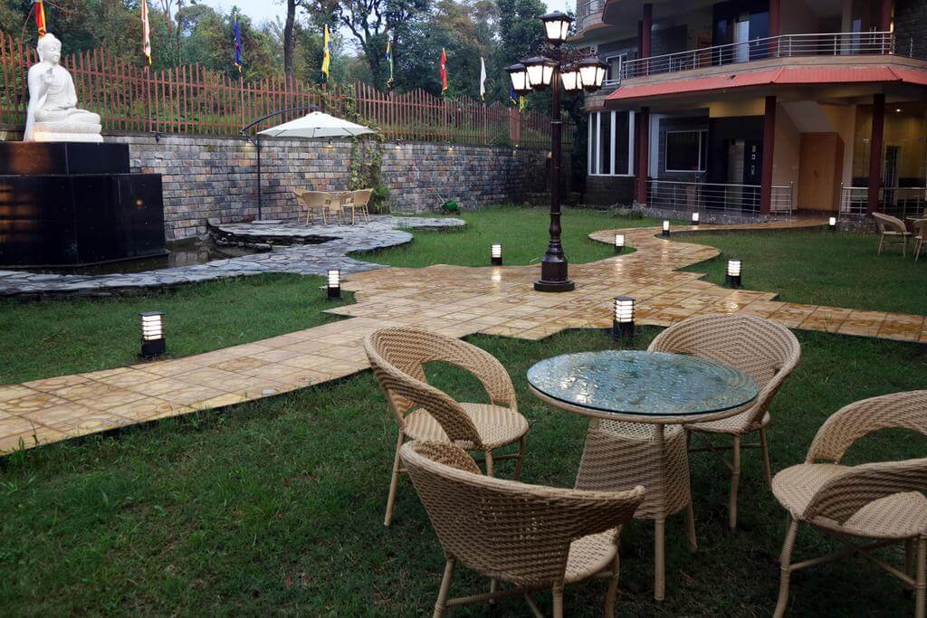 bamboo chairs in a green lawn in hotel