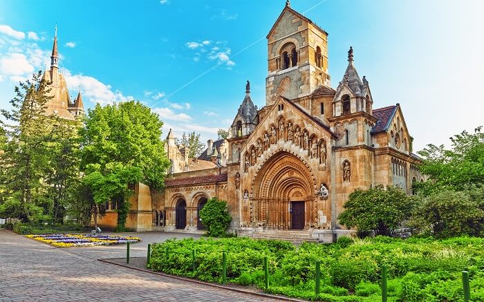 a gorgeous church surrounded by green trees
