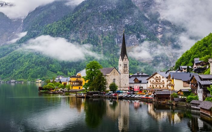 an incredibly gorgeous view of churches and homes by a lake