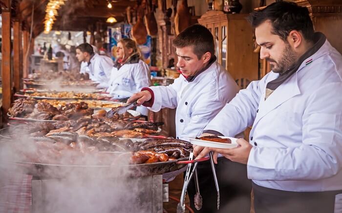 chefs cooking street food wearing white clothes