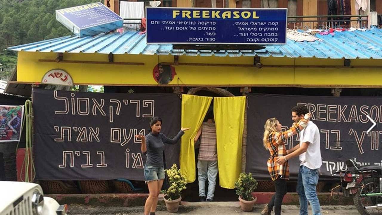 people standing outside a cafe