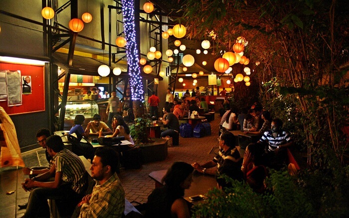 People sitting at the open roof Prithvi Cafe in Juhu