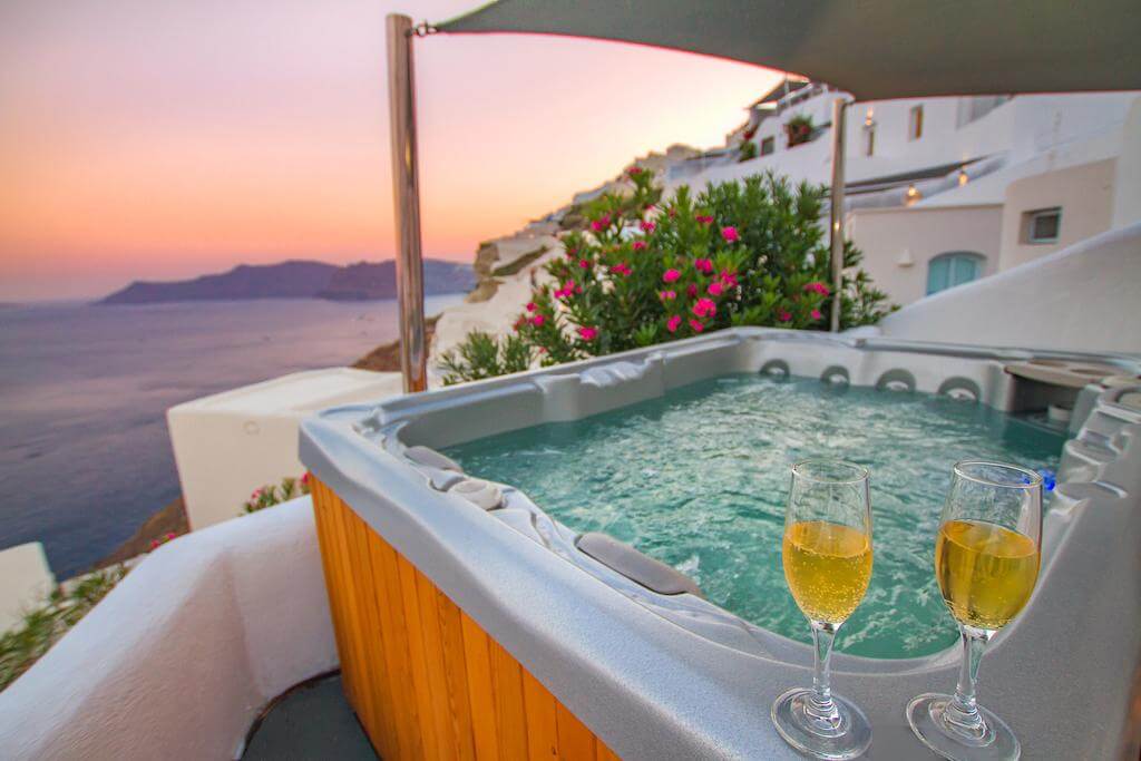 a hot pool with a glass of alcohol