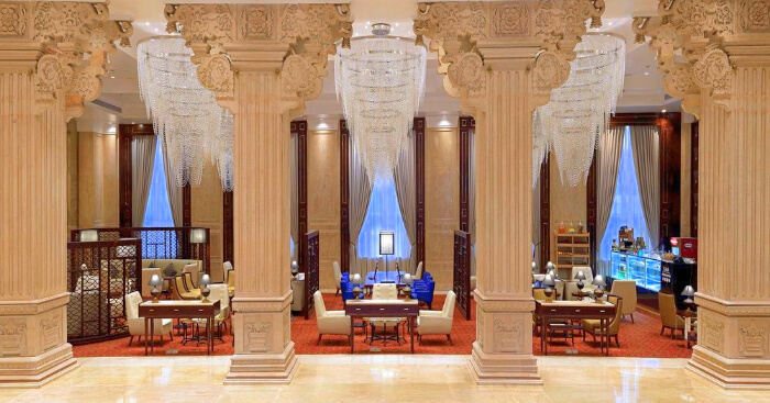 a hotel dining area with chandelier