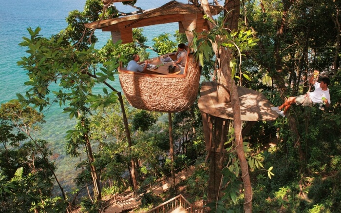 A view of people dining at Soneva Kiri Resort in Thailand