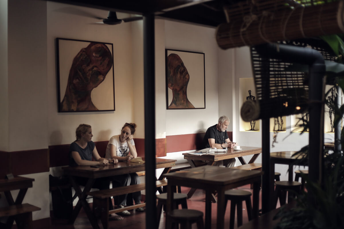 people sitting in an old cafe of Kochi