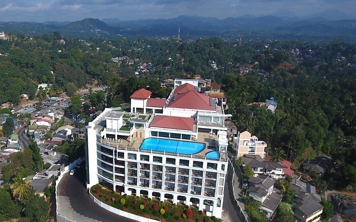 a grand hotel with a terrace pool