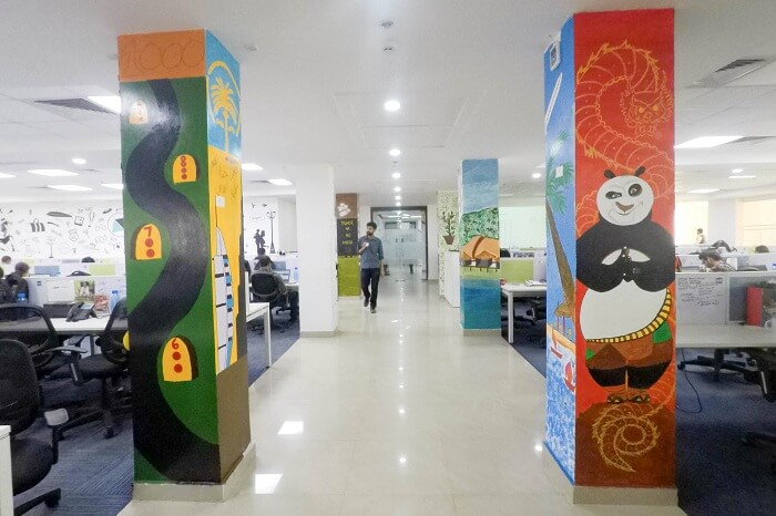 A view of the business bay at TravelTriangle with painted pillars