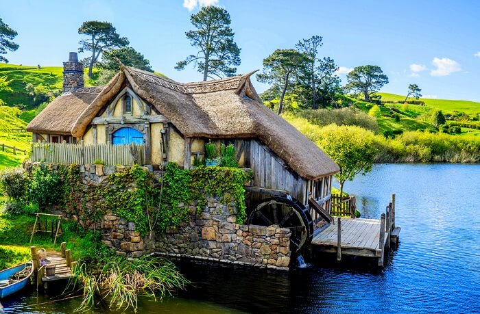 a beautiful Hobbit house by a lake