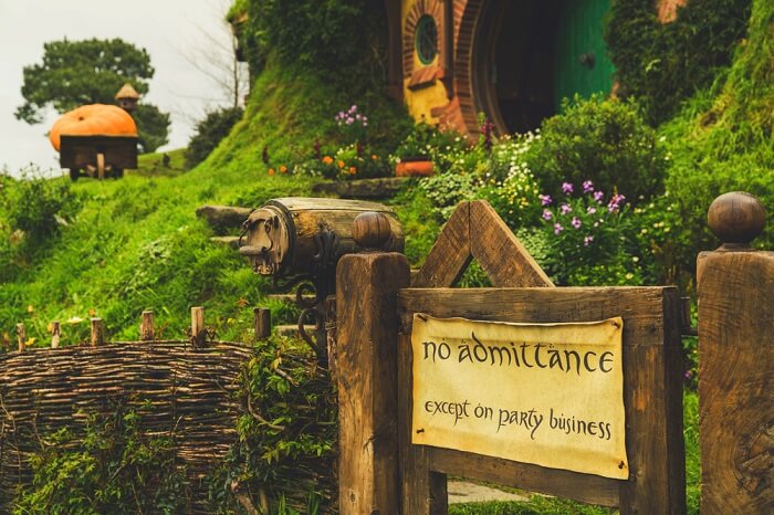 a wooden board outside hobbiton village