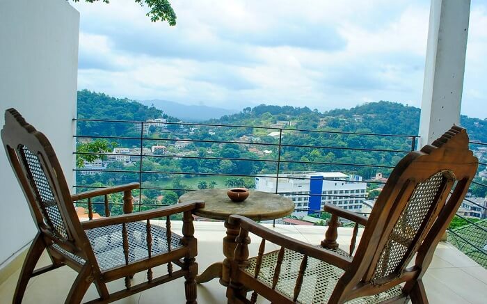 two wooden chairs in balcony with mountain views