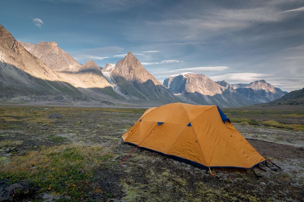 a yellow tent in Auyuittuq National Park