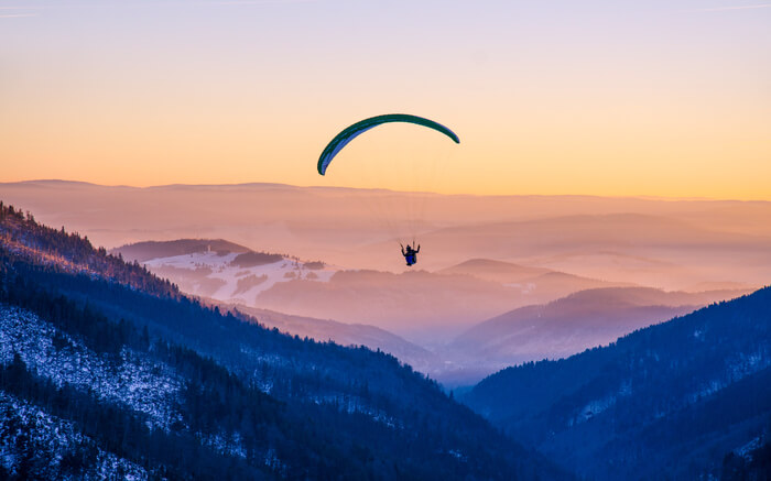 A paraglider in mountains