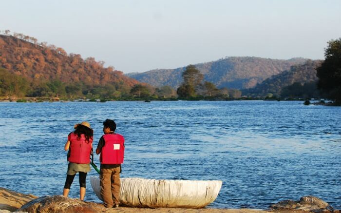 A man and woman standing by the water of Bheemeshwari