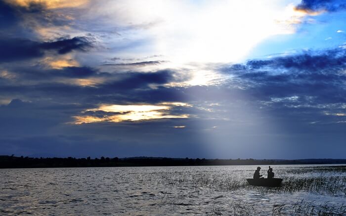 Two people in a coracle on a river