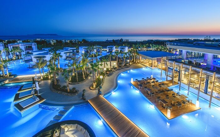 beautifully lit resort with outdoor pools and sitting areas