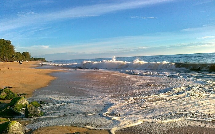 waves wetting the brown sand at Ullal Beach