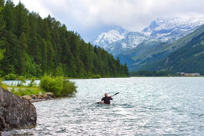 man kayaking in the river in switzerland