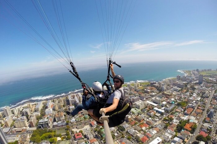 man paragliding in sky